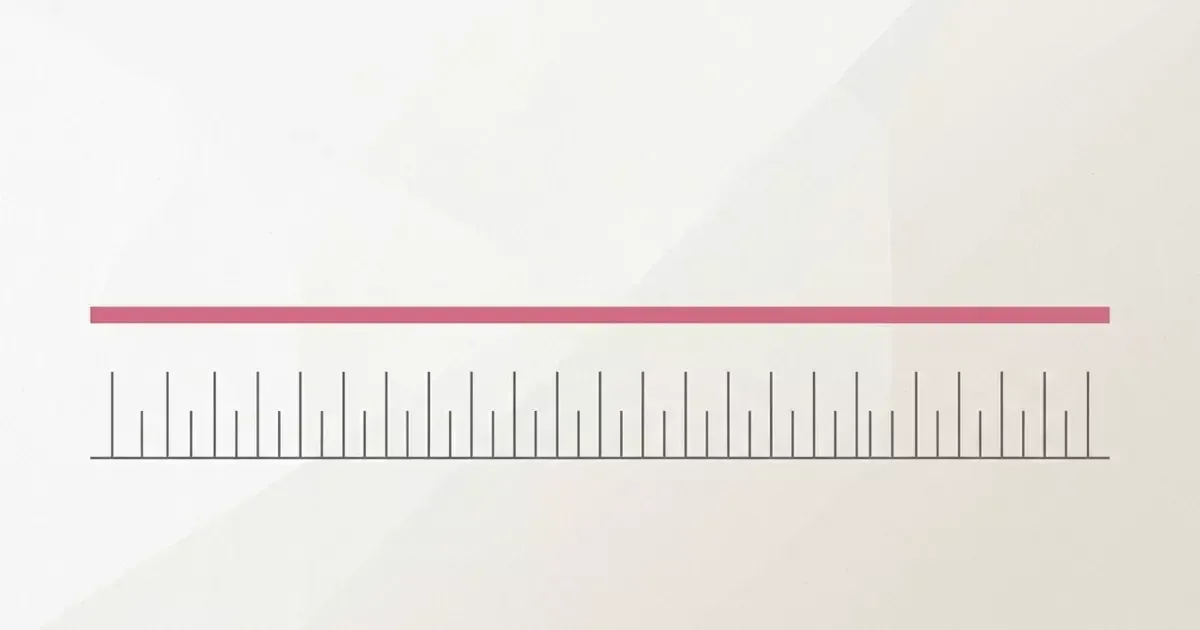 A nearly blank white surface with a pink horizontal bar across it, above a ruler with tick marks.